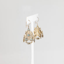 Load image into Gallery viewer, Pair of gold earrings with gemstones on a white stand against a light gray background