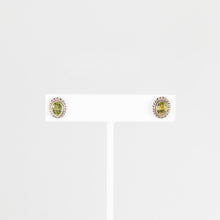 Load image into Gallery viewer, Pair of stud earrings with green gemstones on a white background