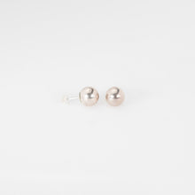 Load image into Gallery viewer, Pair of pearl earrings on a light gray background