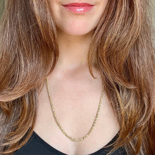 Load image into Gallery viewer, Close-up of a person wearing a gold necklace with long brown hair.
