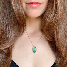Load image into Gallery viewer, Close-up of a person wearing a necklace with a green pendant.