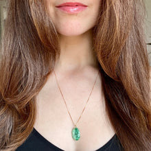 Load image into Gallery viewer, Close-up of a person wearing a green pendant necklace with long brown hair.