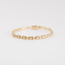 Load image into Gallery viewer, Gold bracelet on a light gray background