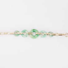 Load image into Gallery viewer, Gold bracelet with green gemstones on a light gray background