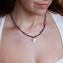 Load image into Gallery viewer, Person wearing a purple beaded necklace with a heart pendant.