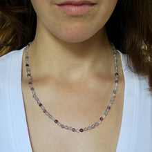 Load image into Gallery viewer, Necklace with multicolored beads worn by a person in a white top.