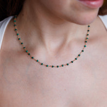 Load image into Gallery viewer, Close-up of a person wearing a green beaded necklace on a white background