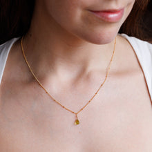 Load image into Gallery viewer, Woman wearing a delicate gold necklace with a small pendant.