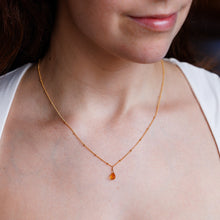 Load image into Gallery viewer, Close-up of a person wearing a delicate gold necklace with a small pendant.