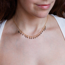 Load image into Gallery viewer, Close-up of a person wearing a delicate necklace with a blurred background