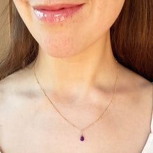 Load image into Gallery viewer, Close-up of a person wearing a delicate gold necklace with a purple pendant.