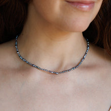 Load image into Gallery viewer, A close-up of a woman wearing a delicate blue pearl necklace.
