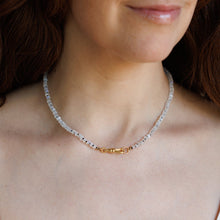Load image into Gallery viewer, A close-up of a woman wearing a delicate beaded necklace with a small gold clasp.