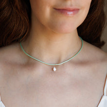 Load image into Gallery viewer, A close-up of a woman wearing a delicate mint green cord necklace with a small CZ pear shape pendant.