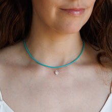 Load image into Gallery viewer, A close-up of a woman wearing a thin turquoise blue cord choker necklace with a small pear shaped CZ pendant.