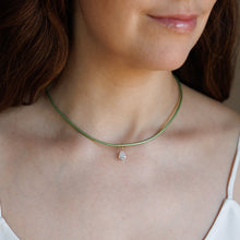Load image into Gallery viewer, A close-up of a woman wearing a delicate green cord necklace with a small pear shape CZ pendant.