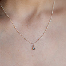 Load image into Gallery viewer, A close-up of a delicate rose gold chain necklace worn on a person's neck, featuring a small teardrop-shaped gray gemstone pendant.