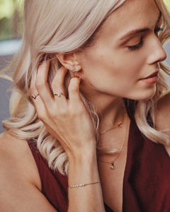 Ceejayeff model wearing delicate gold and diamond jewelry