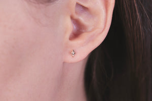 Ceejayeff long star diamond stud earring in yellow gold on an ear