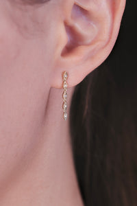 Ceejayeff multi Marq diamond dangle earring in yellow gold on a model